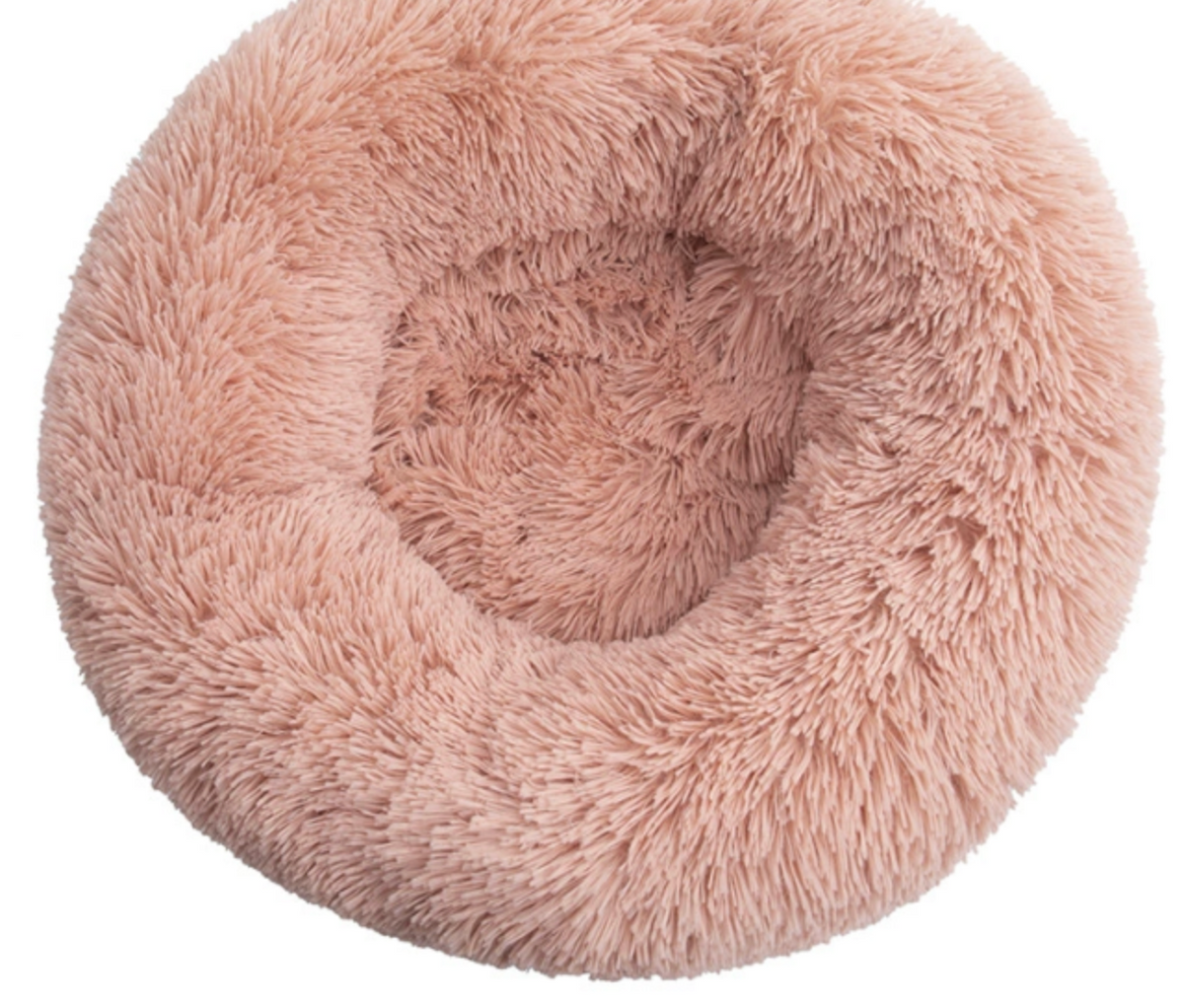 The donut pet bed pressed down to show the loft of the filling