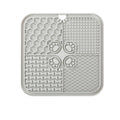 Grey lick mat shown from the back with its suction cup backing