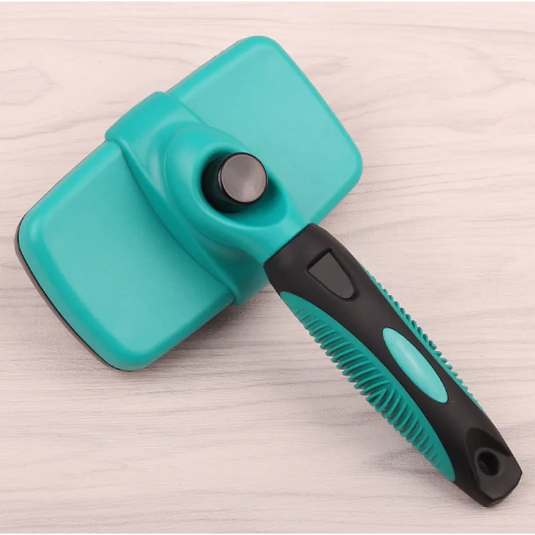 Self-cleaning deshedding comb in dark green with black rubber grip