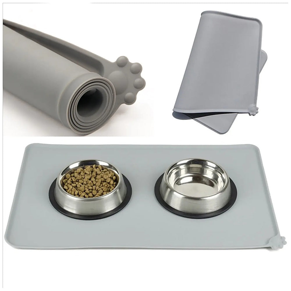 Silicone Pet Feeding Mat — Grey mat rolled up, folded, and laid flat under two steel bowls