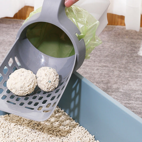 Cat Litter Scoop with Built-In Waste Bin & Sifter — lifting clumps from a litter box while clean litter sifts through